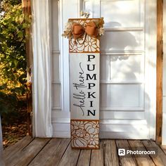 a wooden sign that says pump pumpkin in front of a white door with an orange bow