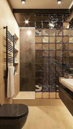 a bathroom with a glass shower door next to a sink