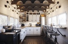 a kitchen with lots of counter space and stools