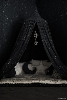 a black and white bedroom with stars on the ceiling