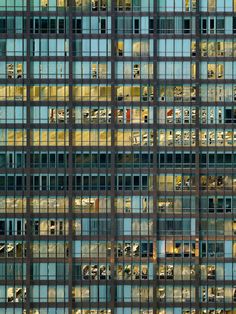 an office building with lots of windows reflecting the light on it's side and inside