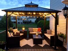 an outdoor patio with lights and furniture