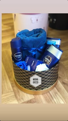 a blue towel sitting in a basket filled with personal care items on top of a wooden table