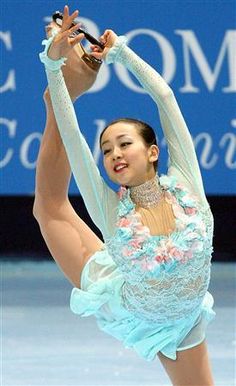 a female figure skating on ice in a competition