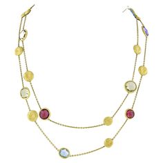 This gorgeous bead station necklace was crafted in Italy from solid 18k yellow gold by Marco Bicego. The long necklace comes from the Jaipur Collection and features fine cable link chain with multiple semiprecious stones that are neatly bezel set and stationed, alternating with brushed finish gold beads throughout the chain. The 13 stones display the most gorgeous colors with amazing amount of shine due to their amazing faceted cutting style. This necklace is 48 inches long and can be worn doubl Marco Bicego Jewelry, Marco Bicego, Circle Pendant Necklace, Station Necklace, Circle Pendant, Multi Stone, Pink Tourmaline, Gold Beads, Beaded Chain