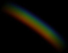 a rainbow is shown in the dark sky