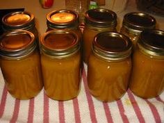 six jars filled with peanut butter sitting on top of a table