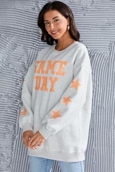 ⚾️ 🏈 🥎 Get ready to cheer on your team in style with our Retro Distressed "Game Day" Sweatshirt! 🌟 Elevate your game day ensemble with this vintage-inspired sweatshirt, designed to showcase your team spirit in a fashion-forward way. It offers both comfort and style as you root for your favorite team. The standout feature of this sweatshirt is the bold "Game Day" inscription in a retro distressed style, giving it a timeless and effortlessly cool vibe. Whether you're tailgating at the stadium o Cotton Sweatshirt With Graphic Print For Game Day, Cotton Graphic Print Sweatshirt For Game Day, Fan Apparel Sweatshirt With Letter Print For Game Day, Team-colored Sweatshirt With Letter Print For Game Day, School Spirit Crew Sweatshirt For Game Day, Varsity Sweatshirt With Lettering For Game Day, Team Spirit Sweatshirt For Game Day With Letter Print, Game Day Fan Apparel Sweatshirt With Lettering, Game Day Crew Neck Sweatshirt With Lettering