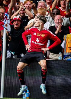 the soccer player is celebrating his team's win in front of an excited crowd