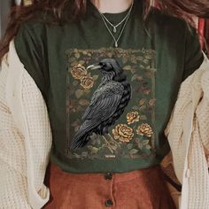 Vintage Raven Shirt, Tarot Card Shirt, Goblincore Shirt, Gothic T-Shirt, Witchy Shirt, Crow, Dark Academia Shirt. 📣 INFORMATION * All shirts are UNISEX * 100% Airlume combed and ringspun cotton (fiber content may vary for different colors) * Wash and dry normally (on cool for best results) 👕 SIZING * For an oversized fit, select two or three sizes up from your normal size * Model is wearing size L * Sizing runs true to size * Most women find their typical size works best, since they are meant Plus Size Goblincore Fashion, Forestpunk Outfits, Cool Shirts Women, Summer Coffee Shop Outfit, Knock Thrice, Hobbitcore Outfits, Dark Cottage Core Fashion, Vintage Shirt Outfit, Witchy Academia Outfit