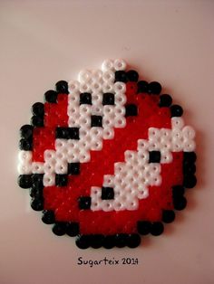 a red and white heart made out of beads