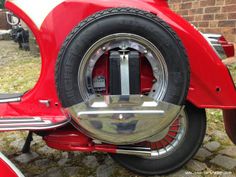 the front tire and fenders of a red motorcycle