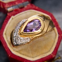 This beautiful low profile ring feature a bezel set pear cut amethyst that is accented to one side with bright diamonds set to complement the shape of the amethyst.  The ring is crafted in 14k yellow gold and is currently a size 6.5. Antique Engagement Rings Sapphire, Amethyst Rings, Amethyst Cocktail Ring, Amethyst Ring Vintage, Estate Jewelry Rings, Wedding Ring Diamond Band, Amethyst Jewelry, Antique Engagement Rings, European Cut Diamonds