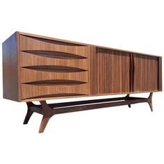 the sideboard is made out of wood and has three doors, two drawers and one shelf