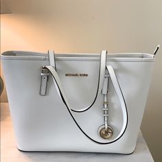 White Micheal Kors Shoulder Bag. Like New Condition, Small Mark On Bottom (See Pictures). Five Interior Pockets, One Zippered Pocket, Zipper Closure. 16 Inches Right To Left, 6.5 Inches Front To Back, And 10.5 Inches Top To Bottom. White Michael Kors Purse, Michael Kors White Bag, Large Leather Bag, Embossed Bag, Mk Purse, Animal Print Shoes, Michael Kors Shoulder Bag, Black Leather Handbags, Large Shoulder Bags