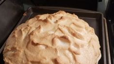 an uncooked pie sitting on top of a baking pan in the oven, ready to be baked