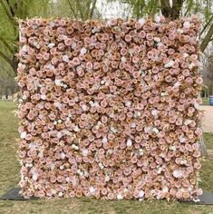 a large square shaped sculpture made out of pink and white flowers