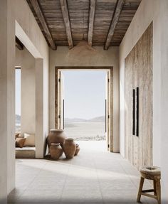 an open room with two vases on the floor and a bench in front of it