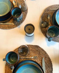 the table is set with blue and green dishes