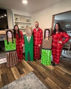 three people dressed in pajamas and masks standing next to cardboard boxes with faces on them