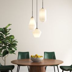 a dining room table with green chairs and a bowl of fruit on the centerpiece