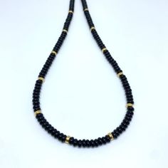 This necklace is crafted with smooth onyx beads adorned with gleaming gold accents. This luxurious piece is an elegant and timeless accessory for any occasion. Length 16" A powerful protection stone, Black Onyx absorbs and transforms negative energy, and helps to prevent the drain of personal energy. Onyx can open the chakras and allow the better flow of positive energies. Root chakra -This information is intended for spiritual support only- Beads about 4x2mm Spacer 4x2mm Findings 14K GF Gold Onyx Beaded Necklaces With Gemstone Beads, Gold Onyx Gemstone Beaded Necklaces, Gold Onyx Beaded Necklaces With Black Beads, Gold Beaded Necklace With Black Onyx Beads, Gold Onyx Beaded Necklace With Black Beads, Black Rondelle Gemstone Bead Necklace, Onyx Bead Necklaces For Meditation, Spiritual Gold Necklace With Black Beads, Onyx Beaded Necklaces For Meditation