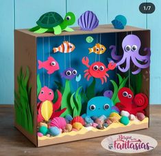 an ocean scene made out of cardboard with sea animals and fish in the bottom right corner