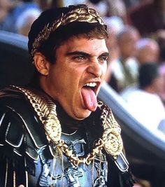 a man with his tongue hanging out in front of an audience at a sporting event