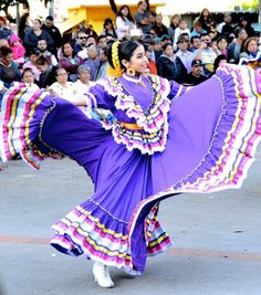 a woman is dancing in front of a crowd