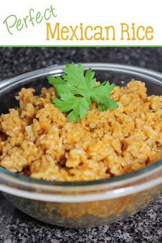 mexican rice with cilantro and parsley in a glass bowl on a granite countertop