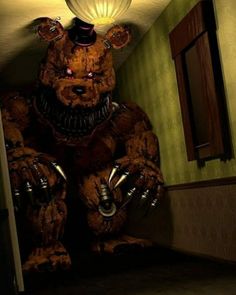 a large brown teddy bear standing in a hallway next to a mirror and light fixture