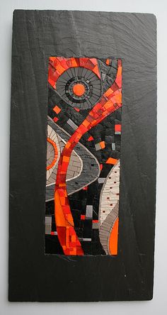 a piece of art that looks like it has been made out of black and orange squares