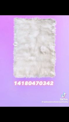 a white fur rug on top of a purple background