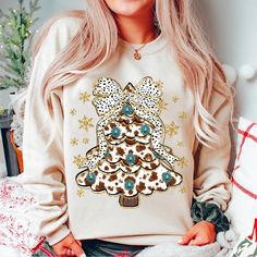 a woman with blonde hair wearing a christmas tree sweatshirt