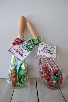 two bags filled with candy sitting on top of a wooden table next to a rolling pin