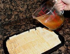 a person pouring something into a container on top of a pan filled with breadcrumbs