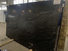 a large black marble slab in a warehouse