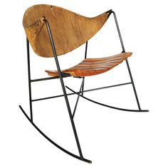 a wooden rocking chair sitting on top of a metal frame