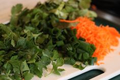 chopped carrots and parsley on a cutting board