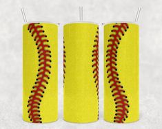 two yellow cylindrical cylinders with red laces on them