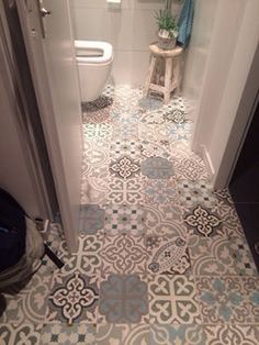 a white toilet sitting in a bathroom next to a doorway