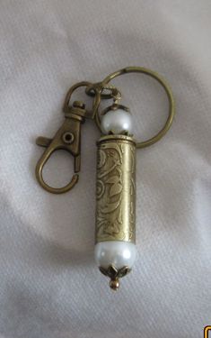 an antique brass lighter key chain with pearls