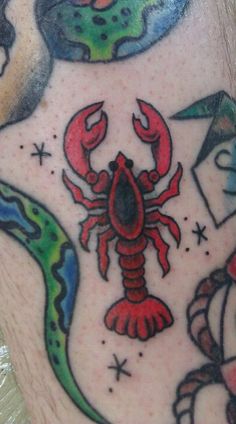 a man's leg with tattoos on it and a crab in the middle of his legs