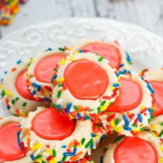 some cookies with sprinkles on a white plate