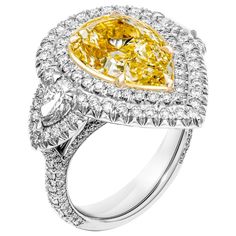 a fancy yellow diamond ring with diamonds around it