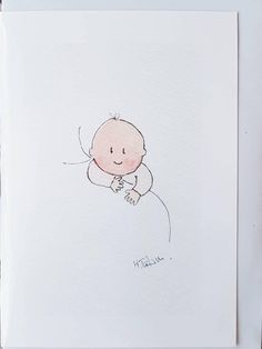 a drawing of a baby in a white frame on a wooden surface with the word hello written below it