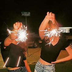 two girls are holding sparklers in their hands