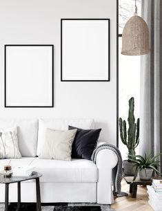 a living room with a white couch and some plants