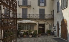 an outside view of a building with tables and umbrellas