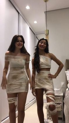 two women in short dresses standing next to each other